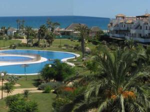an aerial view of a resort with a swimming pool at Mediterranea 2 Vera Playa Jardines tus momentos frente al mar in Vera +14 photos