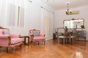a dining room with a table and chairs and a mirror at Ellis house in Agrinio
