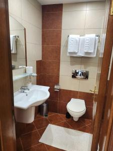 a bathroom with a sink and a toilet at Royal Plaza Apartments Borovets in Borovets