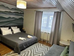 a bedroom with a bed with two towels on it at Зоряні Карпати in Slavske
