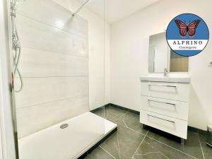 a white bathroom with a shower and a sink at Le Sportif, spacieux et moderne in Limoges