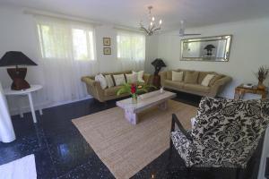 a living room with couches and a coffee table at Chateau Elysium - Two bedroom villa 2 in Beau Vallon