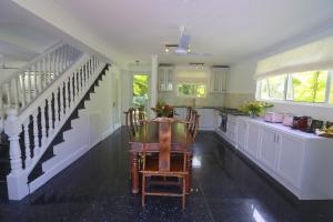 a kitchen with a staircase and a table and chairs at Chateau Elysium - Two bedroom villa 2 in Beau Vallon