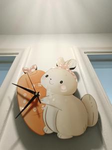 a teddy bear on a wall with an umbrella at Arte Cheras Duplex Near MRT 1 in Kuala Lumpur