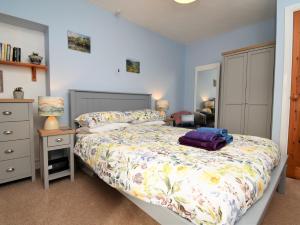 a bedroom with a bed and a dresser with a purple bag on it at 1 bed property in Langwathby Cumbria SZ113 in Langwathby