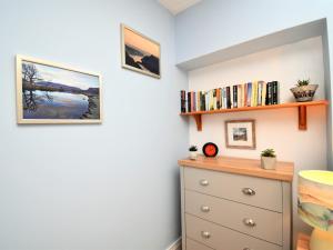 a bedroom with a dresser and a shelf with books at 1 bed property in Langwathby Cumbria SZ113 in Langwathby