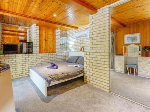 a bedroom with a bed in a brick wall at 1 bed in Sandown 85248 in Sandown