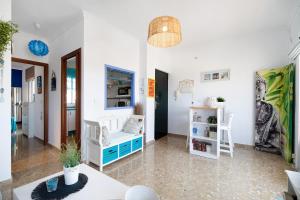 a living room with a couch and a table at Apartamento La Barca - Chipiona in Chipiona