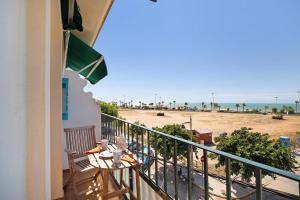 a balcony with a view of the beach at Apartamento La Barca - Chipiona in Chipiona