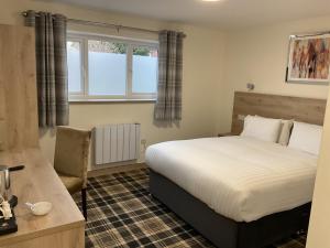 a bedroom with a bed and a window at The Claremont Preston in Preston