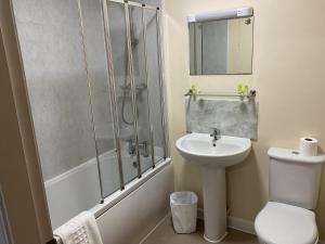 a bathroom with a shower and a toilet and a sink at The Claremont Preston in Preston