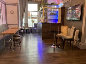 a restaurant with tables and chairs in a room at The Claremont Preston in Preston