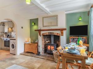 a living room with a fireplace and a table at 2 Bed in Bacton 86430 in Bacton