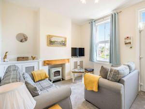 a living room with two couches and a fireplace at 2 Bed in Newby Bridge 87621 in Newby Bridge