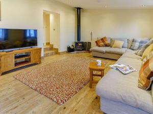 a living room with a couch and a flat screen tv at 3 bed in Usk 87286 in Llandenny