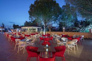 a restaurant with tables and red chairs at Aydinbey Queen’s Palace & SPA in Belek