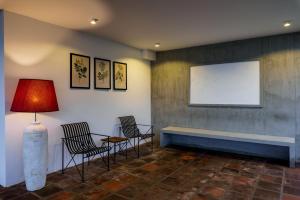 a waiting room with chairs and a table and a window at Grand Beragala Boutique Resort in Beragala