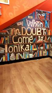 a book wall with a bunch of books at Hostel Amazing Ionika CenterCity in Chişinău