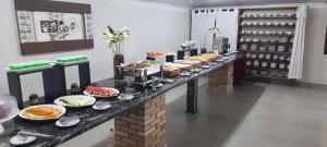 a buffet line with different types of food on it at Leviv Praia Hotel in Caraguatatuba
