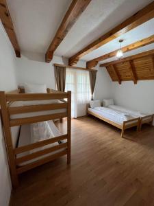 a bedroom with two bunk beds and a window at Bjelasnica-Villa-Treskina dvorišta-Apartmani-Izletište-Ribnjak in Sarajevo