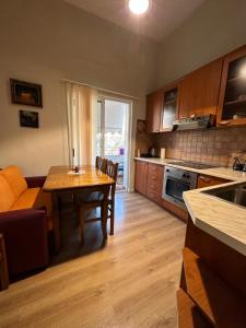 a kitchen and living room with a table and a couch at Kelly's Cozy Hideaway - Central Tirana in Tirana