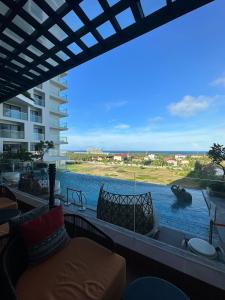 a balcony with a view of a body of water at Apec Mandala Phu Yen Condotel in Liên Trì (3)