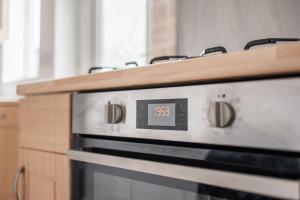 a clock on top of an oven in a kitchen at Rochester House in Middlesbrough