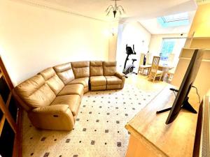 a living room with a couch and a table at Sapphire Family Ensuite XL Room near QE & UOB in Birmingham