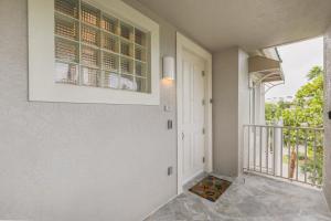 a hallway of a home with a door and a balcony at Ibis At The Sanctuary A302 in Sanibel