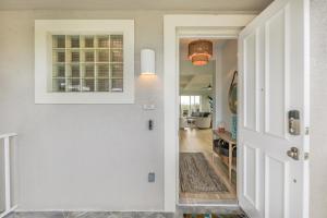 a hallway with a door leading to a living room at Ibis At The Sanctuary A302 in Sanibel