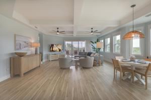 a living room with a table and chairs and a couch at Ibis At The Sanctuary A302 in Sanibel +23 photos