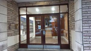 an entrance to a building with a glass door at Departamento Casino in Mar del Plata
