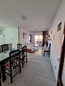 a living room with a table and chairs and a couch at Bonito Apartamento California 6 in Miami Platja +25 photos