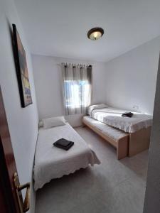Ένα ή περισσότερα κρεβάτια σε δωμάτιο στο Bonito Apartamento California 6