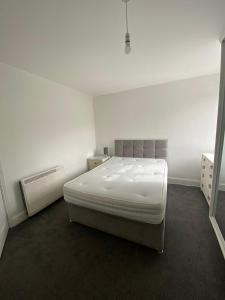 a white room with a large bed in it at Remarkable 1-Bed Apartment in Putney Village in London