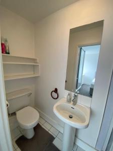 a white bathroom with a toilet and a sink at Remarkable 1-Bed Apartment in Putney Village in London