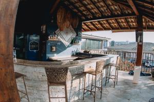 a bar on the roof of a building with stools at Itatiba Orion Hotel in Itatiba