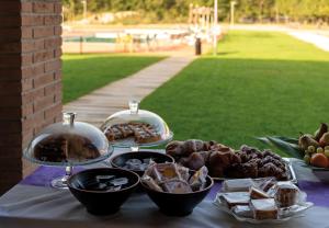 a table with plates of food on a table at Incanto Glamping village in Savio di Ravenna
