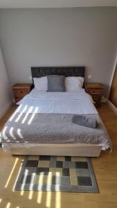 a bedroom with a large bed with a rug at Spacious Victorian Double Room 3 in Balby