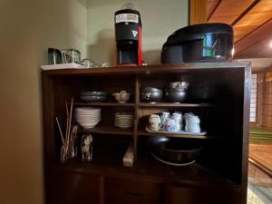 a shelf with dishes and cups and a coffee maker at Marina and Numazu DX1F - Vacation STAY 64527v in Numazu