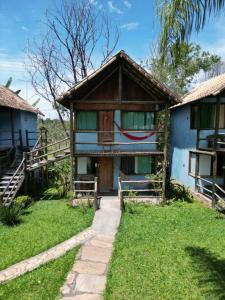 a house with a pathway leading to it at Pousada Recanto dos Cisnes in Betim