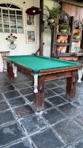 a pool table sitting on top of a patio at Pousada Recanto dos Cisnes in Betim
