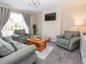 a living room with two couches and a coffee table at The Coastal Hideaway in Hornsea