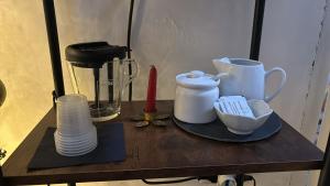 un tavolo con piatti, tazze e frullatore di B&B Visìta_experience a Torre Santa Susanna