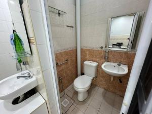 a bathroom with a toilet and a sink and a mirror at Cozy House 37 @ Alma BM in Bukit Mertajam