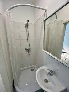 La salle de bains blanche est pourvue d'un lavabo et d'un miroir. dans l'établissement Neuwertiges Apartment mit schnellem WLAN, Glasfaser, Kostenlose Privatparkplatz auch für Transporter geeignet R24, à Freiberg am Neckar