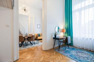 a living room with a table and a dining room at Maverick Apartments in Budapest