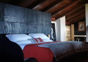 a bedroom with a large bed with white pillows at B&B con SPA il Castello di Lucawest in Ponteranica