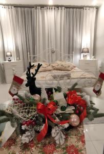 a bedroom with a bed with christmas decorations on a table at Apartament u Danusi in Złoty Stok