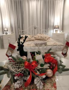 a bedroom with a bed with christmas decorations on a table at Apartament u Danusi in Złoty Stok